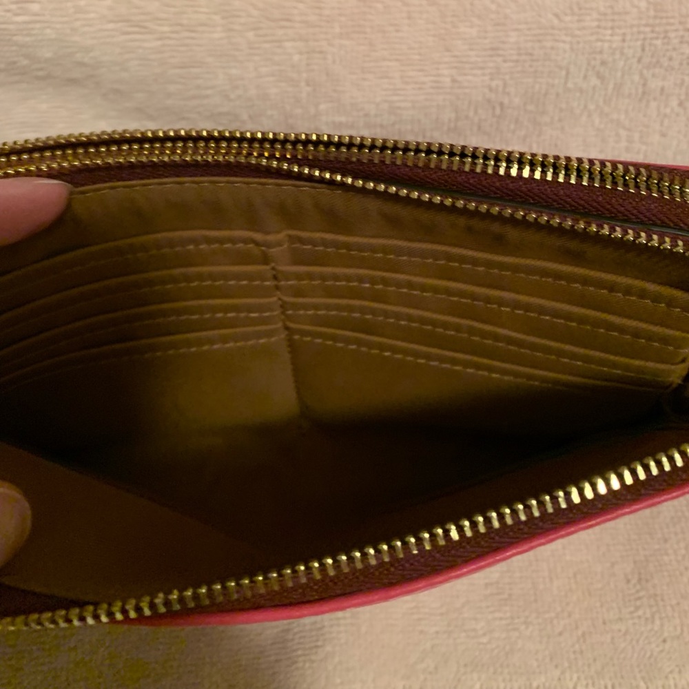 Coach zipper wallet. 8 card slots, very roomy. Held my phone as well
